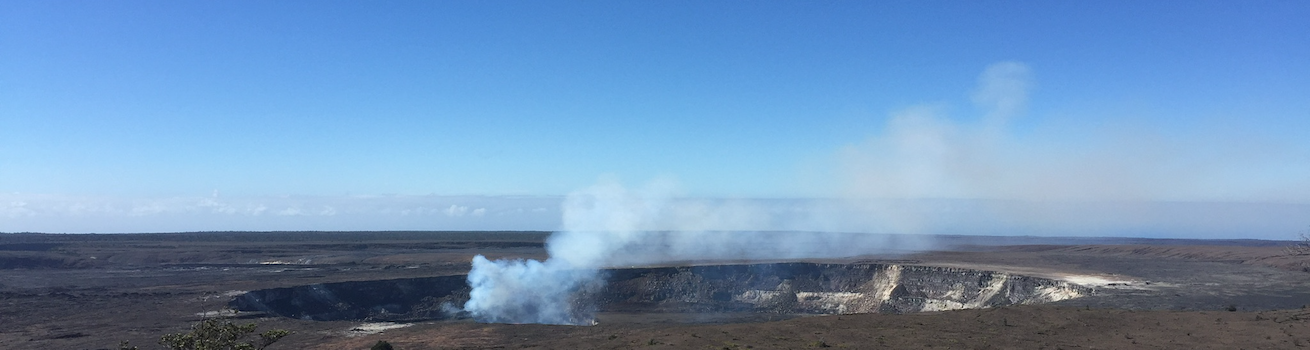 Expertise page header image of volcanic crater emitting plume to sky.