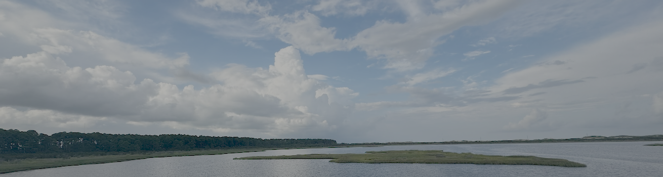 About page header image of cloudy sky over water.